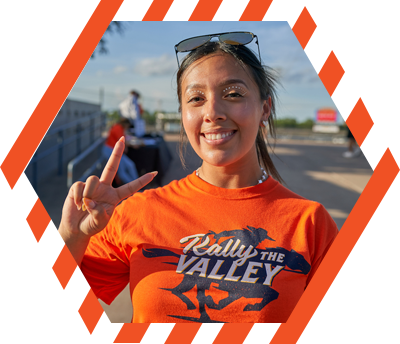 Female student holding the V's Up hand sign