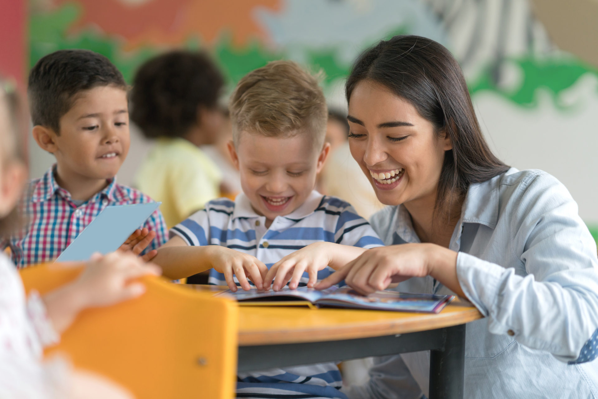 students reading with teacher