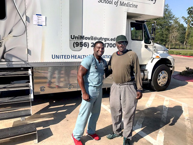 Dr. Charles Lewis (at left), a family medicine resident with the UTRGV Family Medicine Residency Program at Doctors Hospital at Renaissance, poses with a Houston-area resident outside the UTRGV School of Medicine’s mobile clinic, Unimóvil.