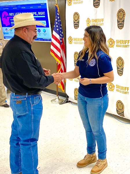 Student from CJA shaking the Sheriff's hand