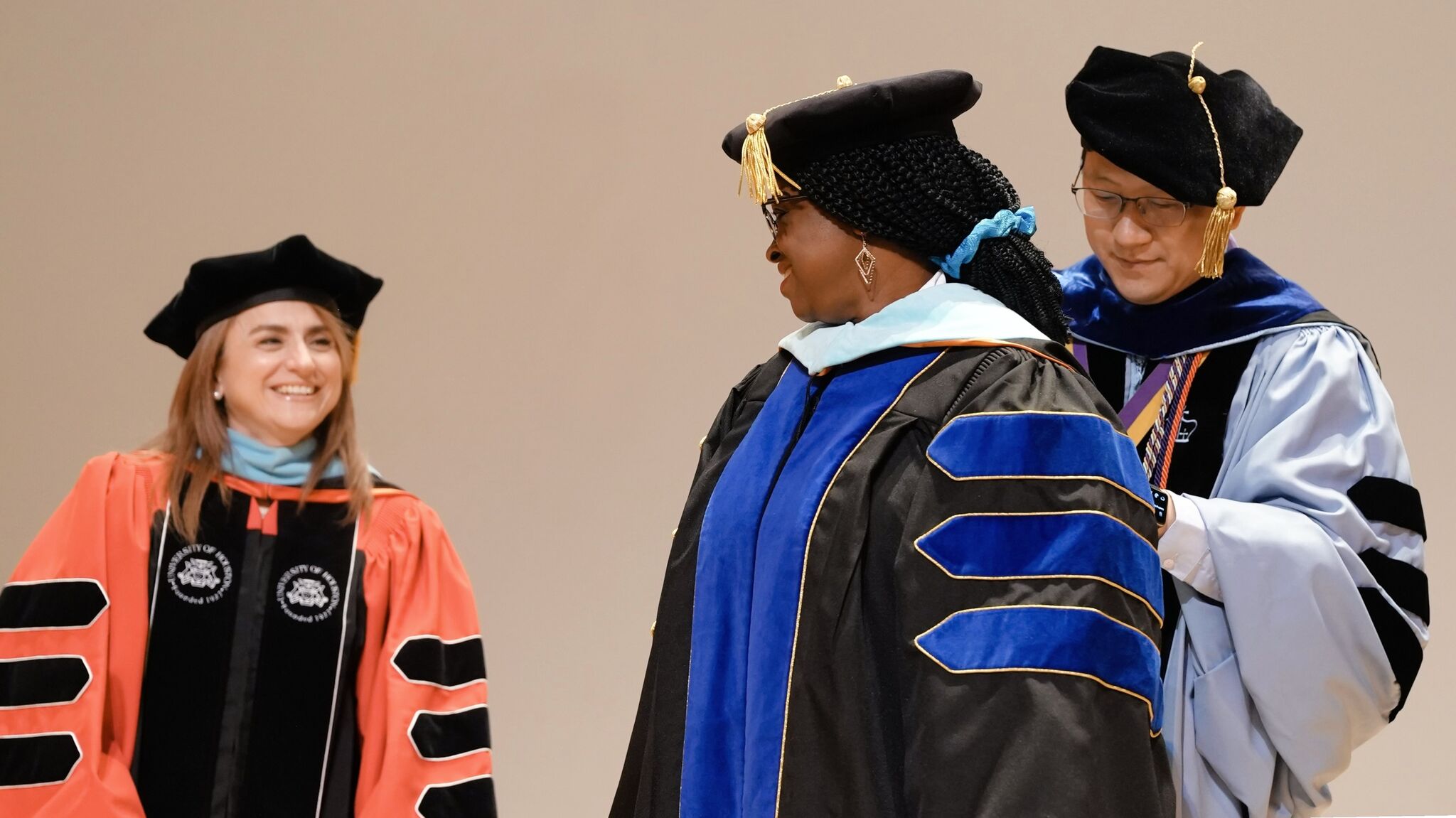 Doctoral candidate Ntiense Otu is hooded by Co-Chair Dr. Ming-Tsan Lu, during the inaugural Doctoral Hooding Ceremony