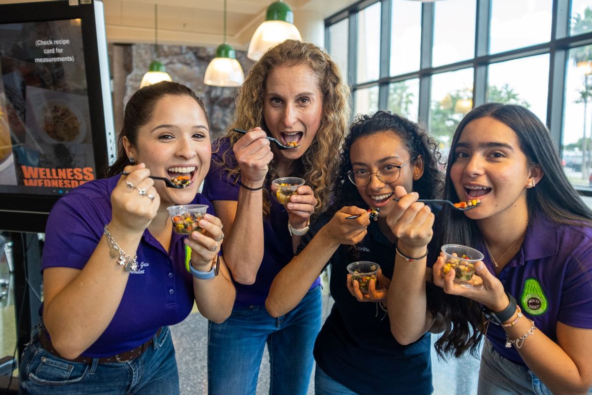 Student preparing food plates to give to the public Page Banner