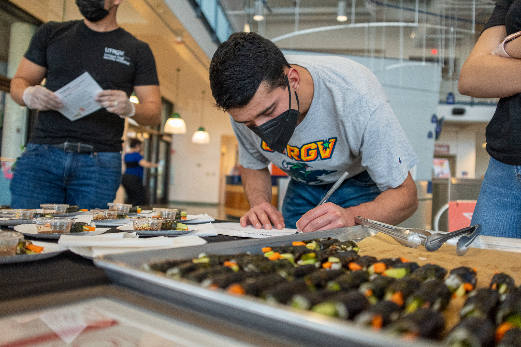 Two CFSI Volunteers setting up their table to give out food samples to the public Page Banner 