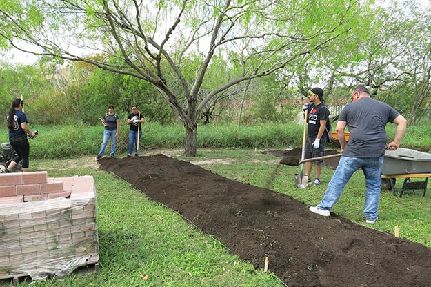 Students add compost to the beds before tilling. Picture: JA Mustard