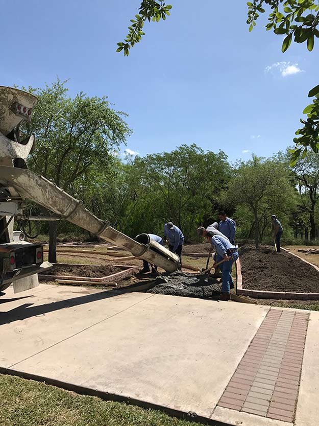The facilities staff pour the concrete for the pathway. Photo: LCarreon
