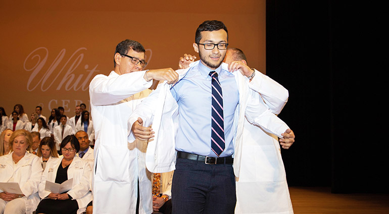 School of Medicine Building student receiving white coat