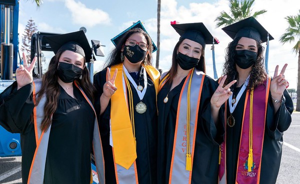 4 UTRGV Graduates wearing masks, UTRGV Archival Photo by Paul Chouy