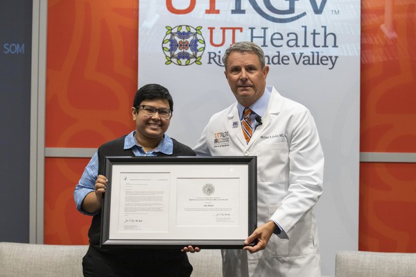 Third-year UTRGV medical student Isha Mittal and Dr. Michael Hocker, dean of the UTRGV School of Medicine, display Mittal's recent U.S. Public Health Service Excellence in Public Health Award. (Photo by Raul Gonzalez)