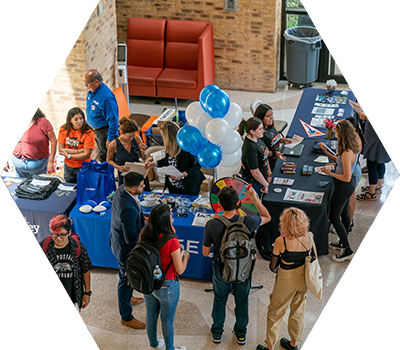 Student event indoor with tables and students and games to play