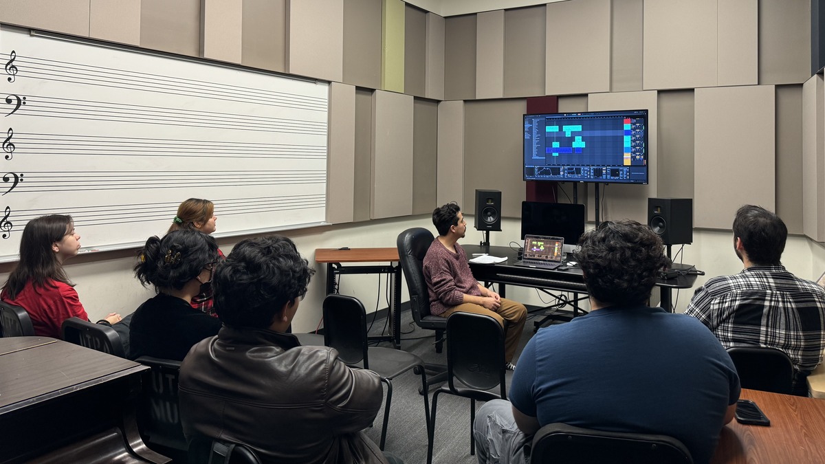 Students watching instructor teaching music on screen