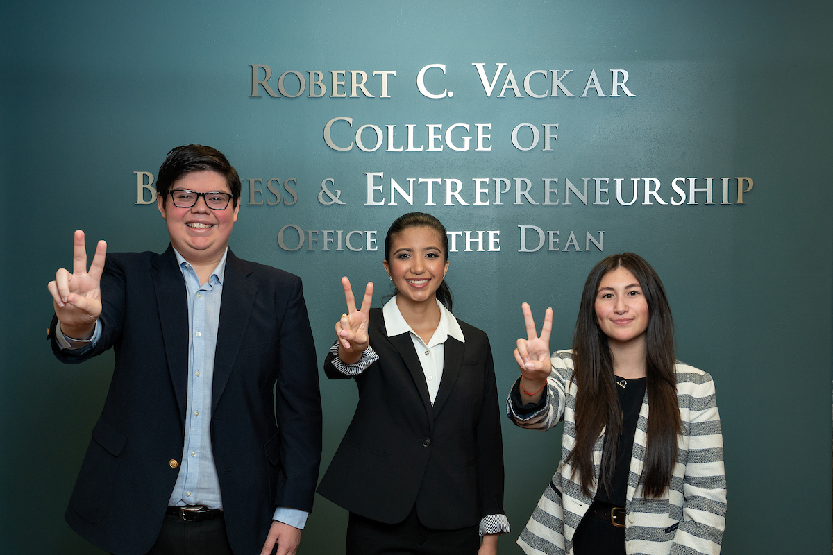 Students in front of Robert C. Vackar College of Business & Entrepreneurship building sign
