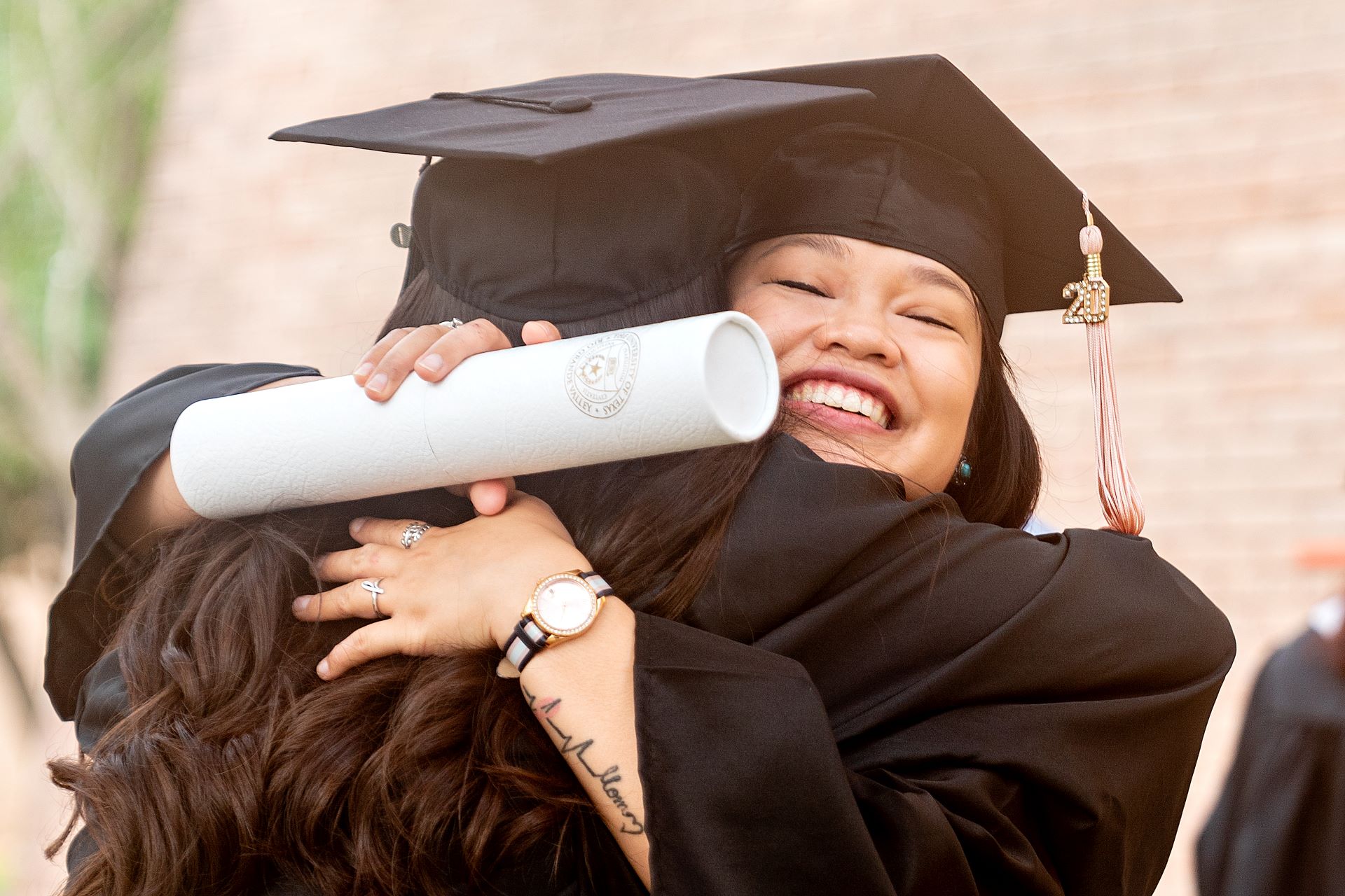 Graduating student hugging