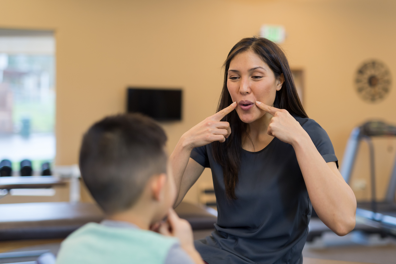 communication disorders professional communicating with student
