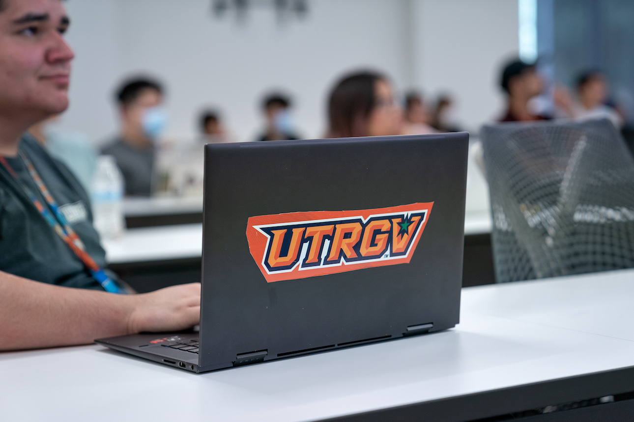 Student with laptop and UTRGV sticker on cover