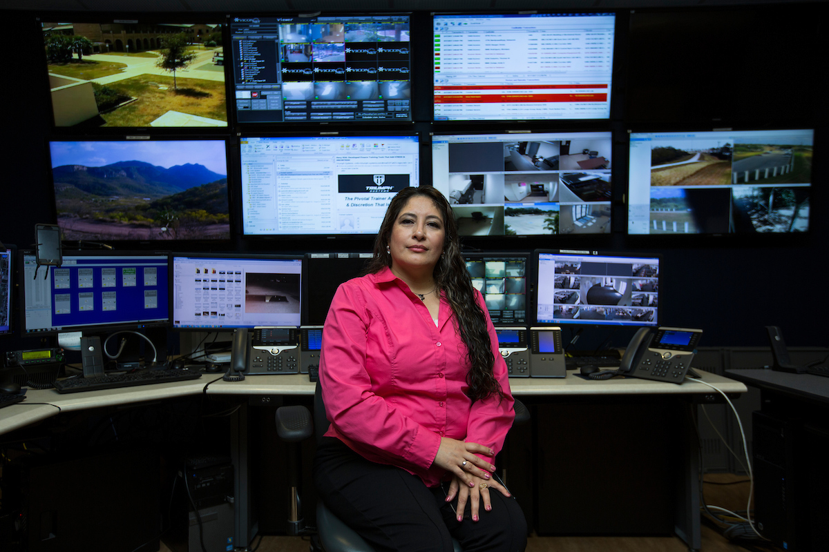 Female professional in station where are many telephones and security cameras monitored by Brownsville and Edinburg operators