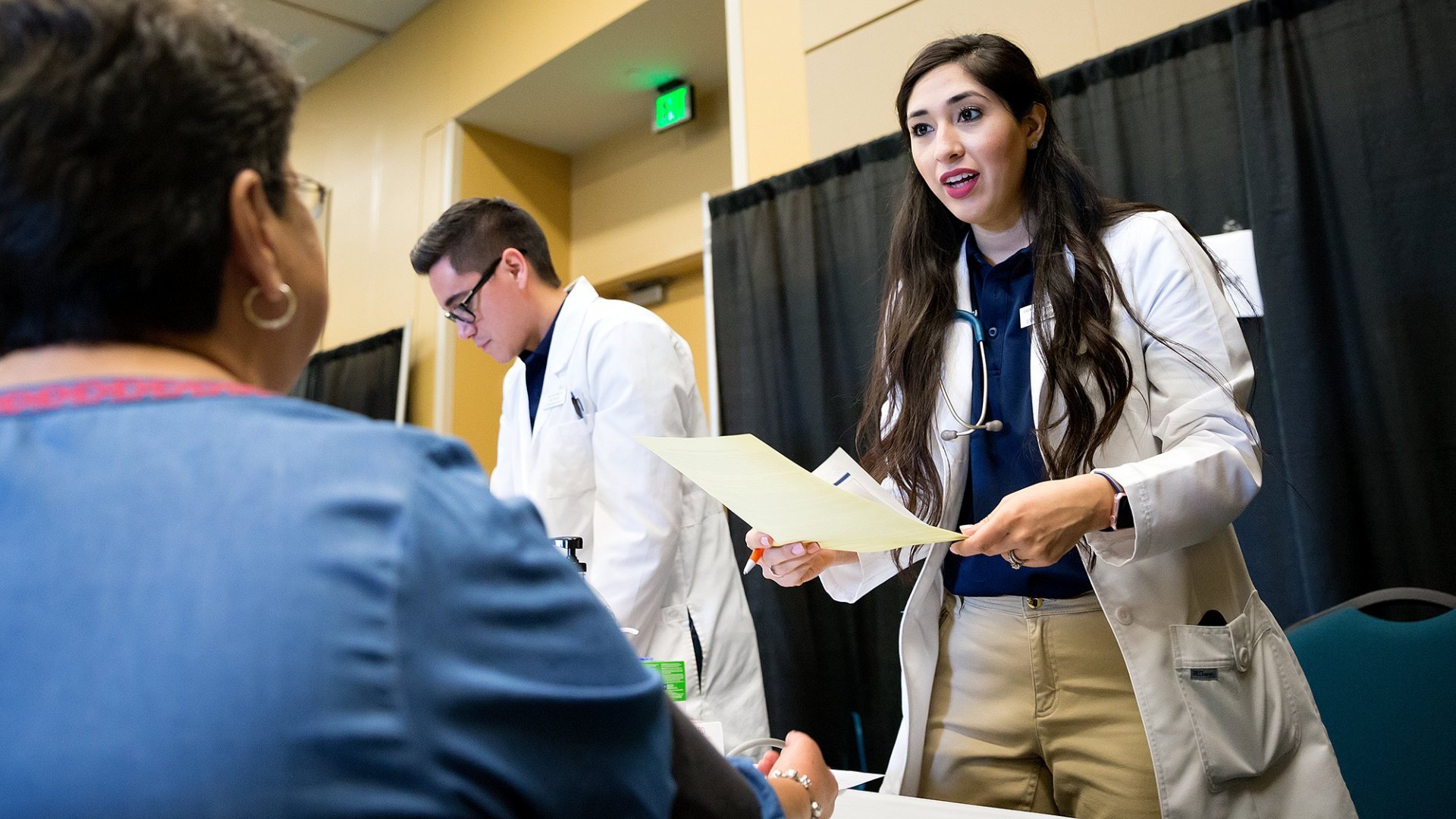 nursing students talking to patient