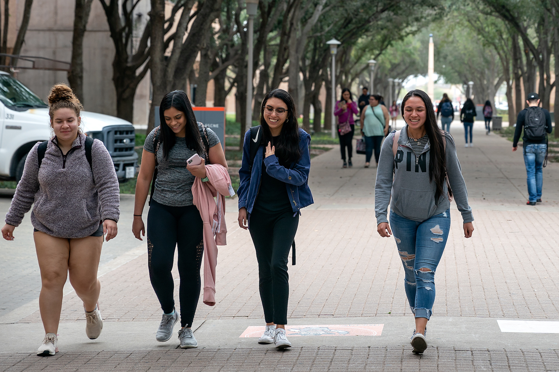 students walking and laughing on campus