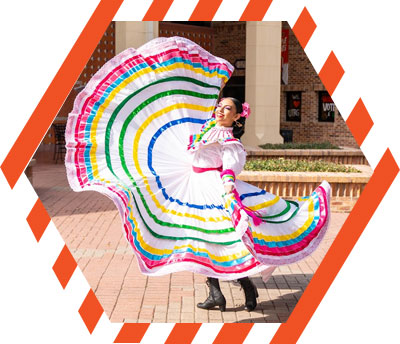 woman dancing and twirling a colorful Mexican dress
