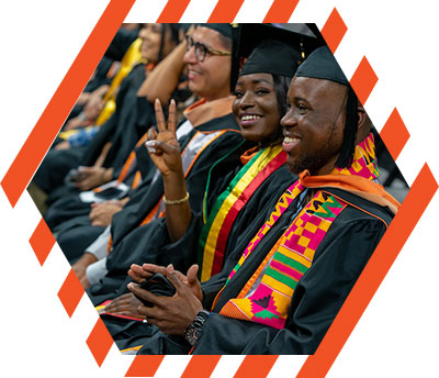 Female gradudate signing the V's Up!