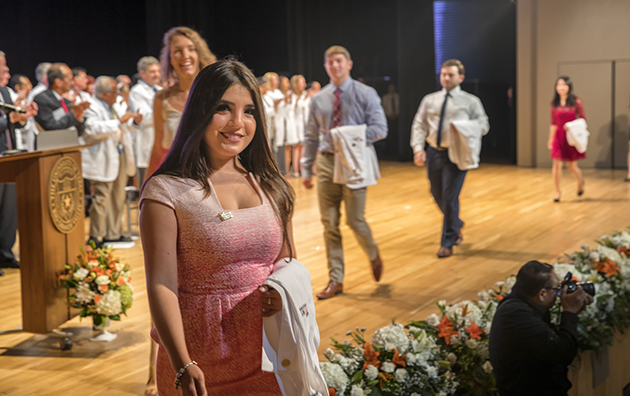 The UTRGV School of Medicine’s Class of 2020 participated Saturday, July 23, 2016, in the traditional White Coat Ceremony, where each new medical student donned the short white coat for the first time. Here, the students are introduced during an entry procession onstage before taking their seats in the audience. (UTRGV Photo by David Pike)