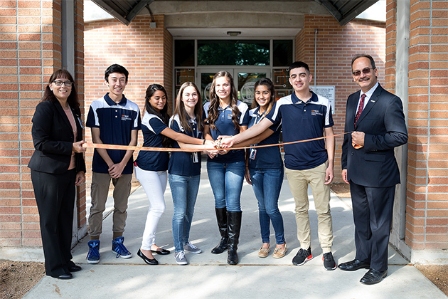 Dr. Wilma Smetter (far left) and Dr. Havidán Rodríguez (far right) and students from the UTRGV Mathematics and Science Academy cut the ceremonial ribbon on Friday, Oct. 21, 2016, commemorating the academy’s expansion from the UTRGV Brownsville Campus to the Edinburg Campus. (UTRGV Photo by Paul Chouy)