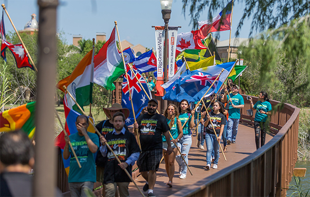 Dozens of international students holding colorful flags from a variety of countries marched across The University of Texas Rio Grande Valley’s Edinburg and Brownsville campuses this week as part of UTRGV’s Best Week Ever celebrations. The International Meet & Greet event was held Wednesday in Edinburg and Thursday in Brownsville. UTRGV has 774 international students representing 60 countries, including Mexico, India, China, Brazil, Venezuela and Bangladesh. The Brownsville Campus Drumline, led by Dr. Joe Moore, led the parade of colorful international flags. (UTRGV Photo by David Pike)
