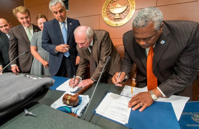 Guy Bailey (center), president of The University of Texas Rio Grande Valley, met with the Harlingen CISD School Board to sign a Memorandum of Understanding that will let Harlingen students take Dual Credit college courses on pathways designed to meet the university’s core requirements for a bachelor’s degree.