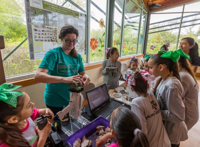 UTRGV geosciences major Brandi Reger works with area children to help identify items in their own rock collections