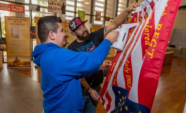 UTRGV students iron out one of the flags for display in the traveling Civil War exhibit