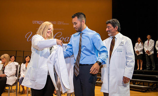 Student in white coat ceremony