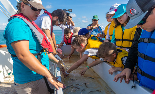 Area children this summer are aboard the R/V Ridley, UTRGV’s floating classroom, to learn about marine life up close and in a hands-on environment through the university’s Coastal Studies Lab summer camps. Children attending use a touch-tank to view and interact with the marine critters pulled up in nets, and get to study plankton under a microscope. They also participate in fun learning projects like hermit crab races and fish painting. (UTRGV Photo by David Pike)