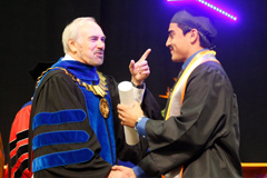 President shaking hands with students