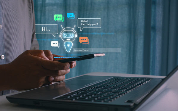 A hand using a phone to enter a prompt