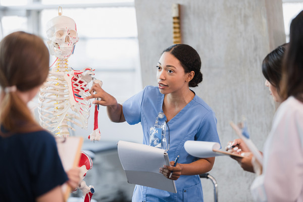 A healthcare professional teaches a group of students