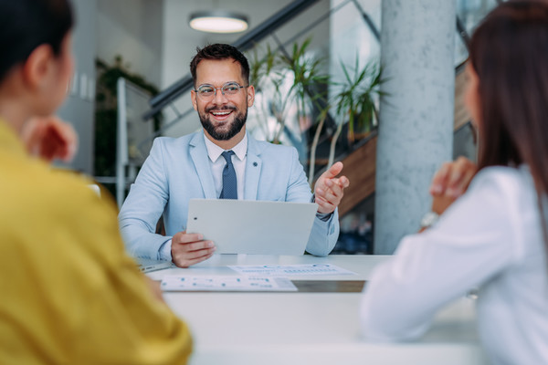young professional man talknig to clients