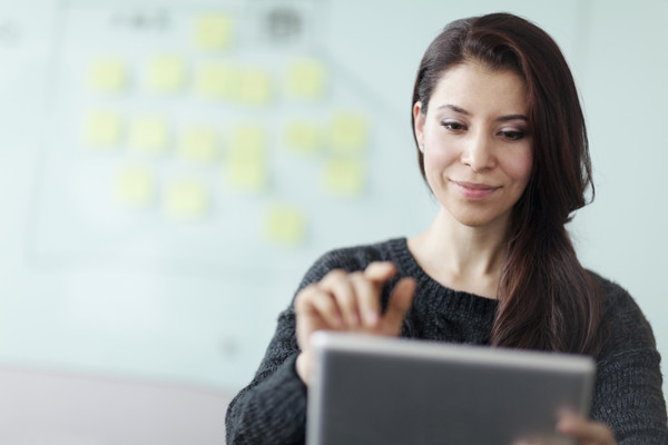 Young woman looking at her tablet