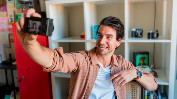 A content creator records a video in his home office.
