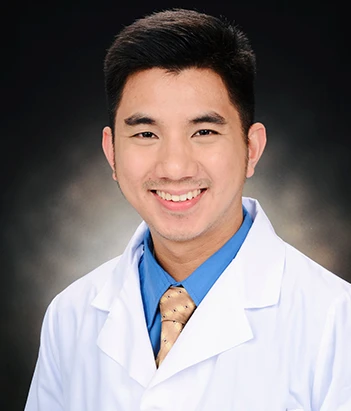 Clinical laboratory scientist smiling while holding a tablet