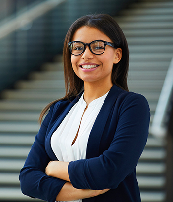 Person smiling while holding paper and a pen