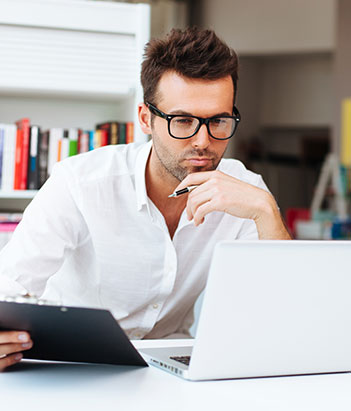 Educational Leadership instructor thinking while holding a pen