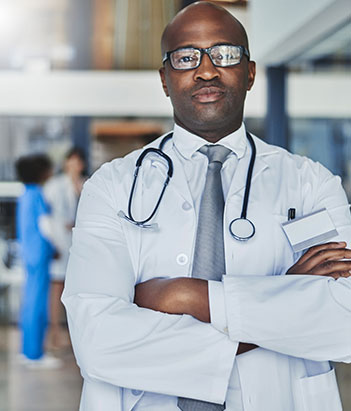 Health care administrator with his arms crossed looking at the camera