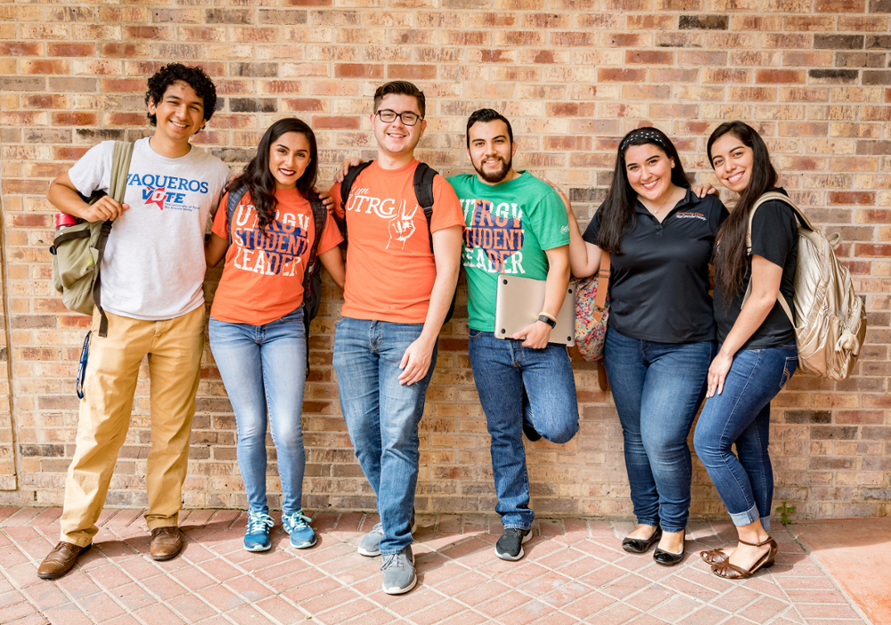Group of students standing and smiling at the camera.
