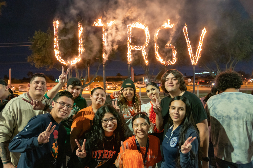 UTRGV burning of the letters with students holding V's Up.