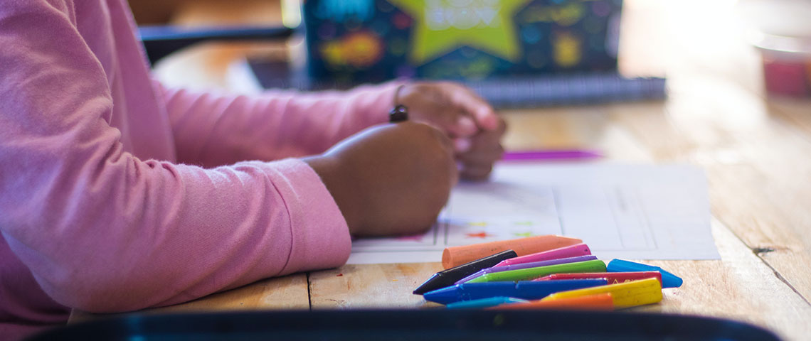 child coloring a coloring book Banner