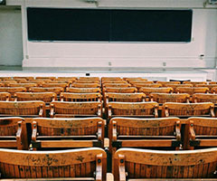 Empty classroom with an empty chalkboard