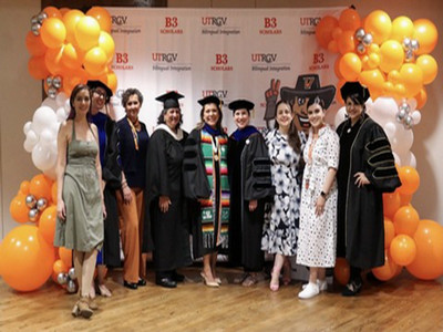 Group of B3 scholars standing celebrating their graduation