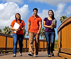 Three students walking in a bridge in the Brownsville campus
