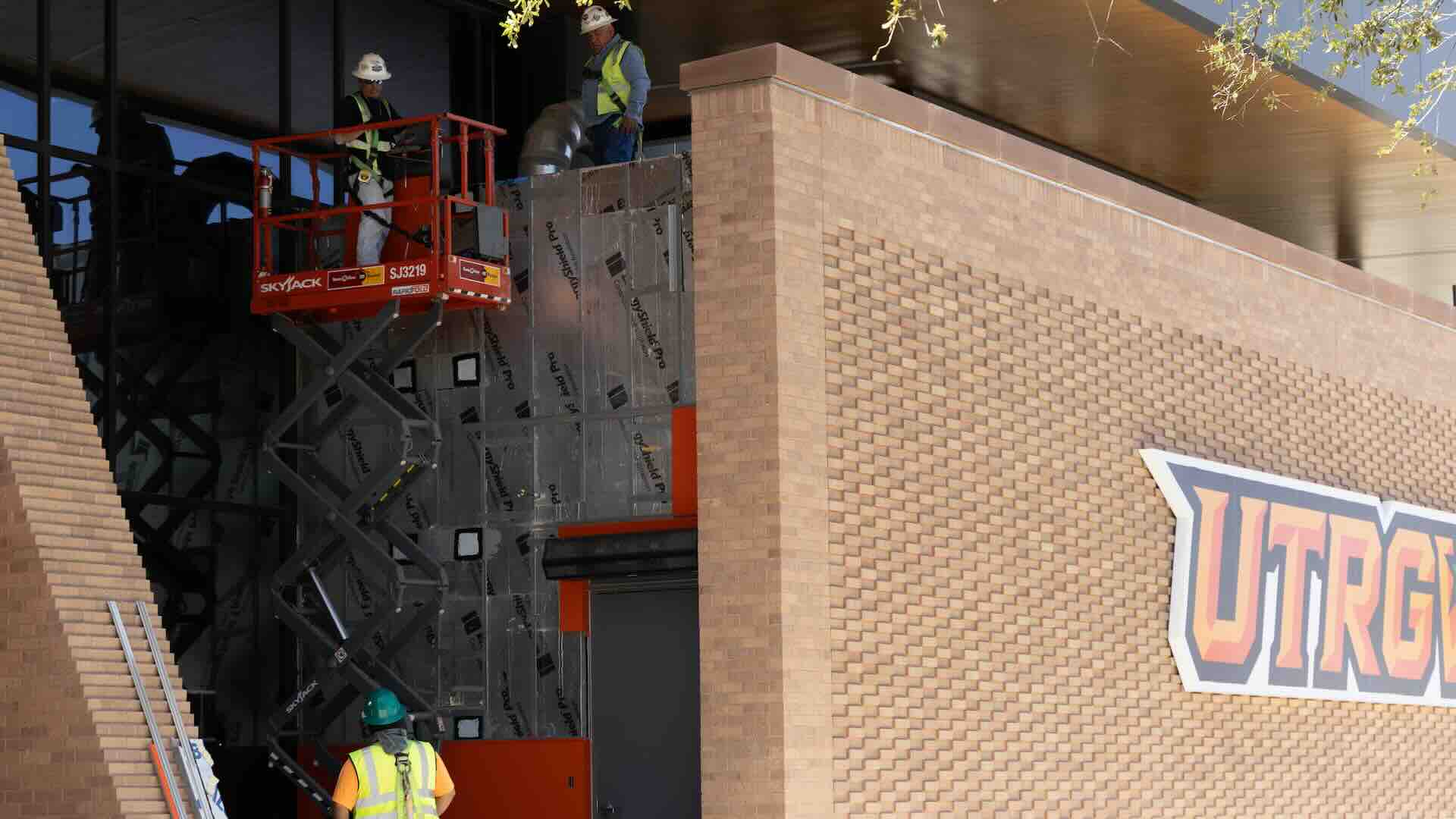 construction workers finishing a wall the the UTRGV Fieldhouse