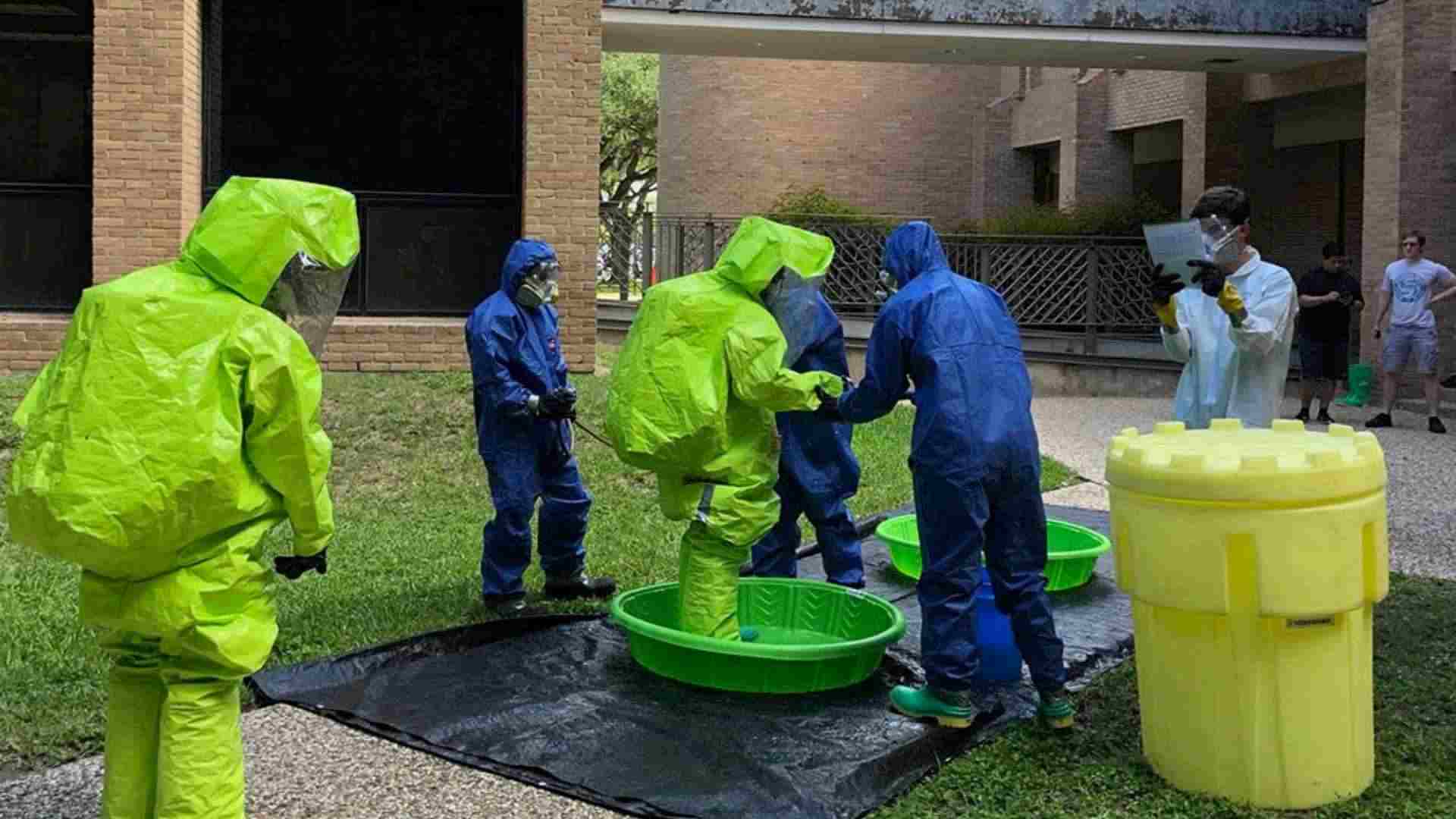 Six people in HAZMAT suits for hazardous waste operation and emergency response standard refresher course training