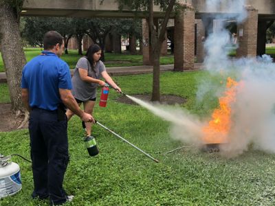 two people doing fire extinguisher training